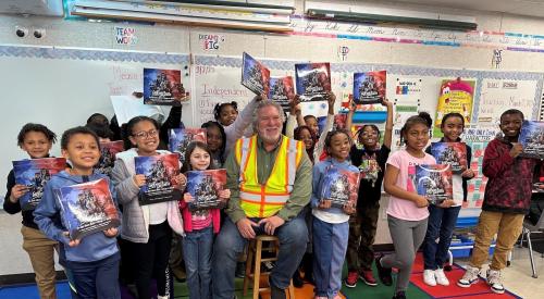 "Grit Leads to Greatness" book reading by a builder to kids in the classroom