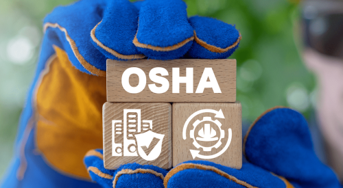 Gloved hands holding wooden blocks with OSHA and other construction site safety symbols