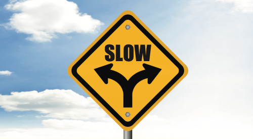Just like this "go slow" road sign, a slowing housing market requires that home builders adjust their approach
