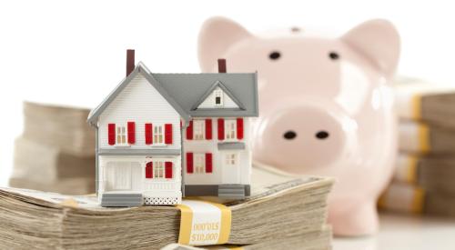 House stacked on money in front of piggy bank