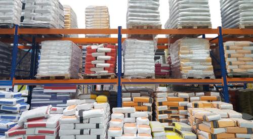 Bags of cement on shelf in building products warehouse